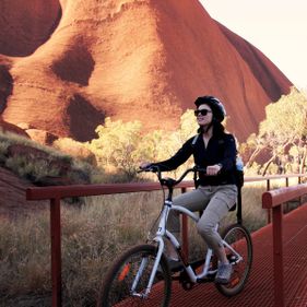 Cycling the base of Uluṟu. Photo: Tourism NT