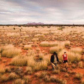 Woman learning about culture in the park with an Anangu guide