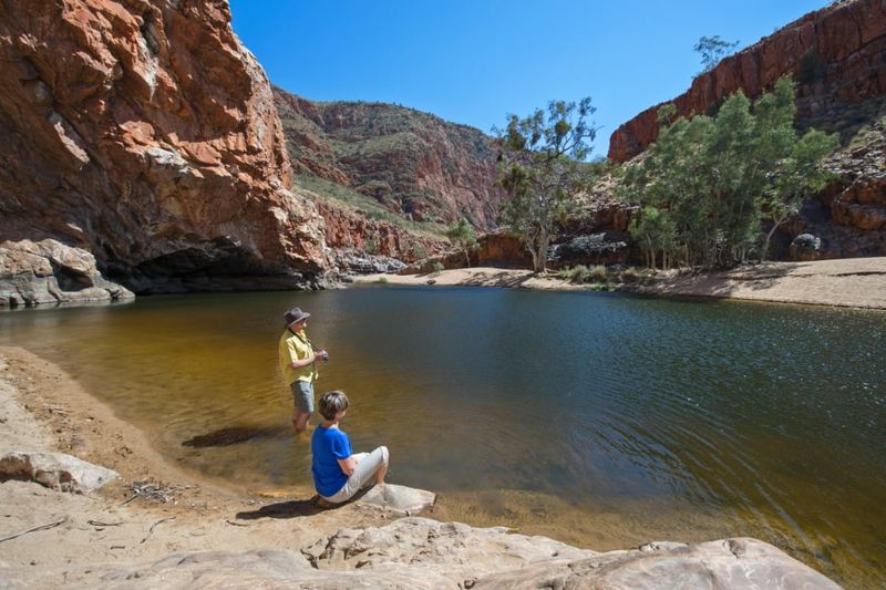 Couple beside a waterhole in Ormiston Gorge.