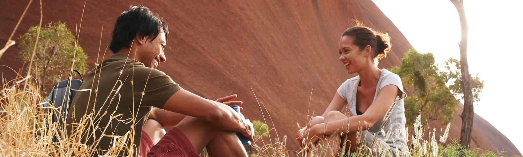 Taking a break beside Uluru. Photo: Tourism Australia