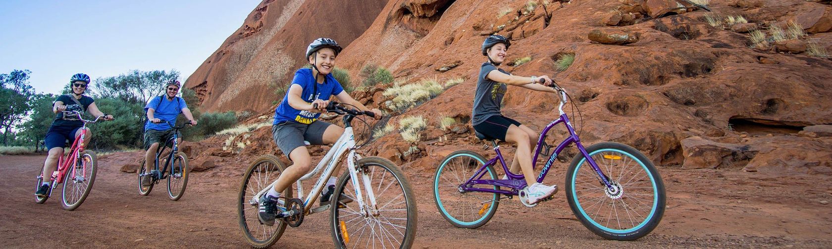 Cycling the base of Uluru. Photo: Outback Cycling